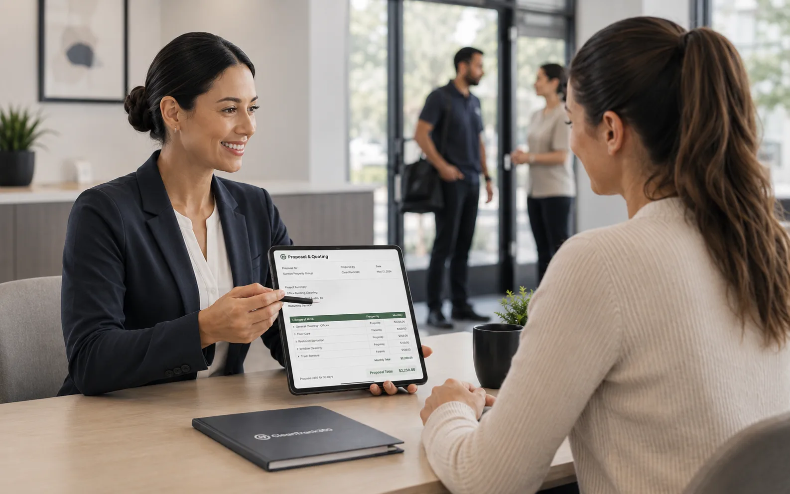 Manager presenting a cleaning proposal to a client on a tablet